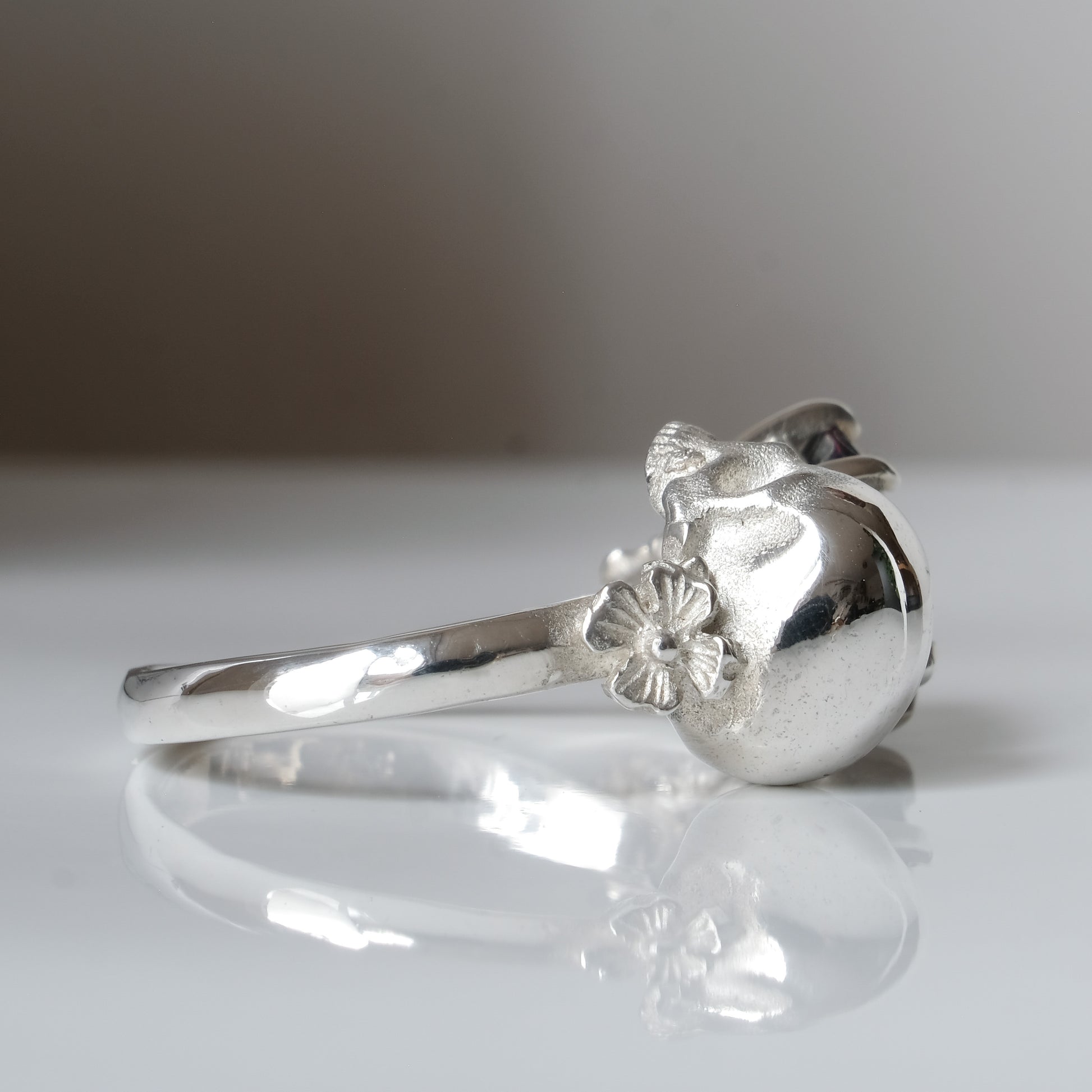 Silver skull and black opal ring with decorative flowers by Charlie Shires jewellery