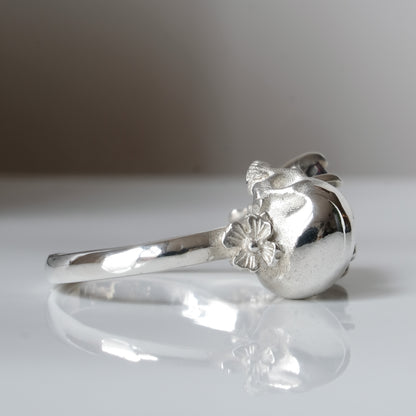 Silver skull and black opal ring with decorative flowers by Charlie Shires jewellery