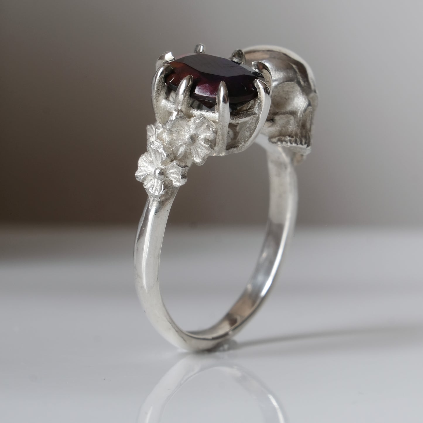 Silver skull and black opal ring with decorative flowers by Charlie Shires jewellery