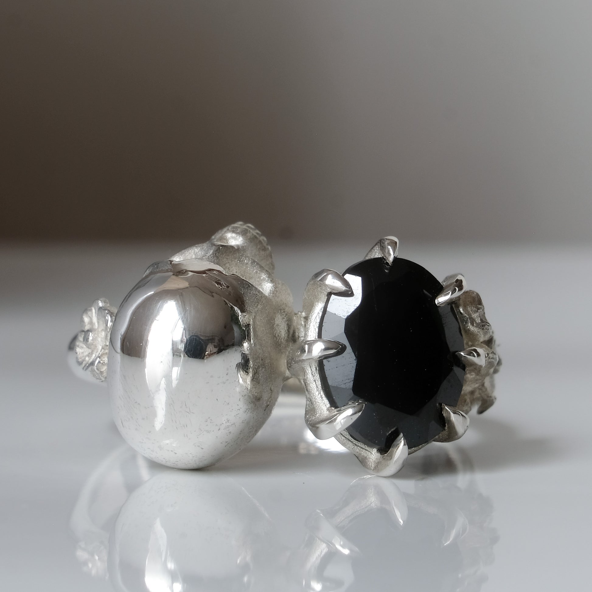 Silver skull and black spinel ring with decorative flowers by Charlie Shires jewellery