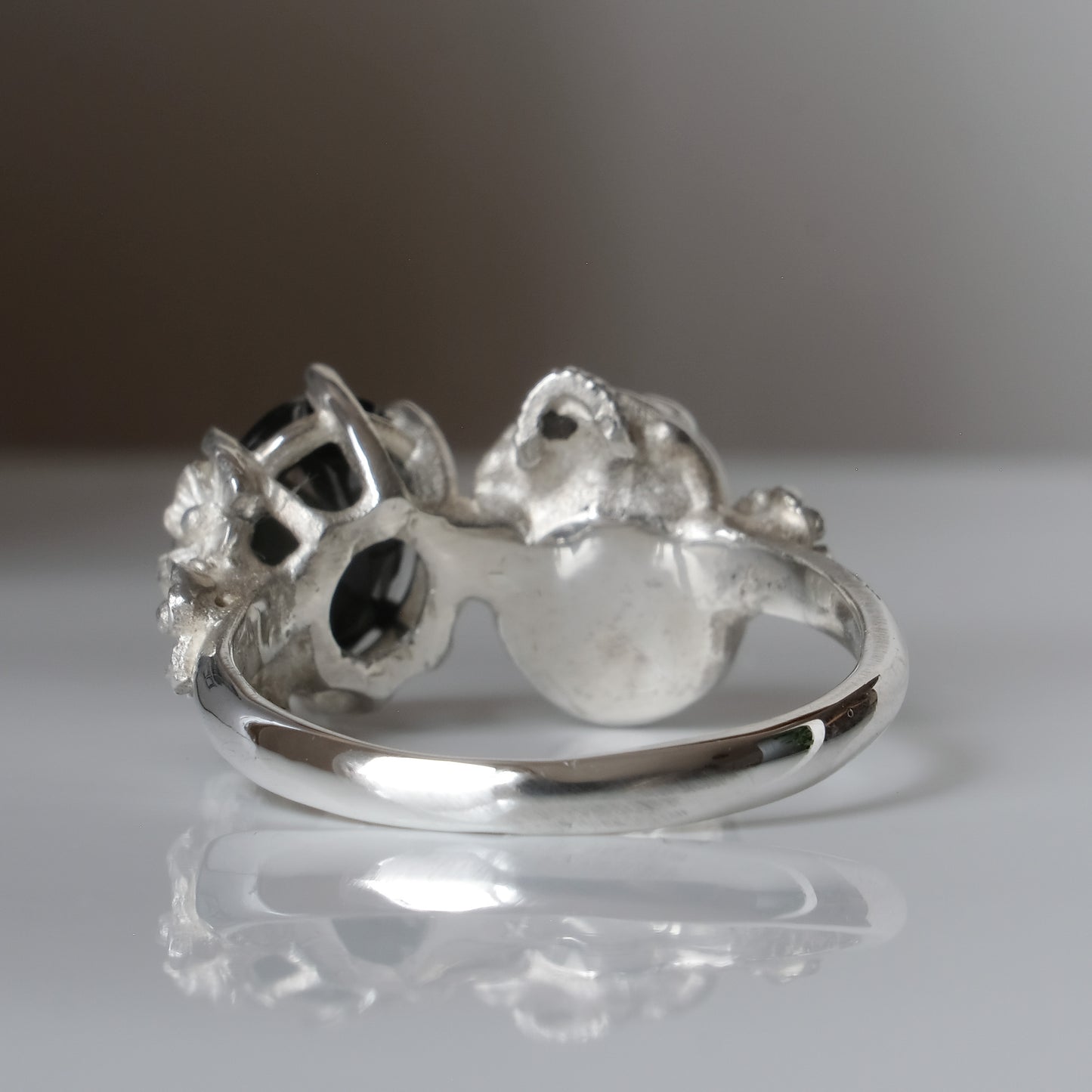Silver skull and black spinel ring with decorative flowers by Charlie Shires jewellery