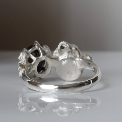 Silver skull and black spinel ring with decorative flowers by Charlie Shires jewellery
