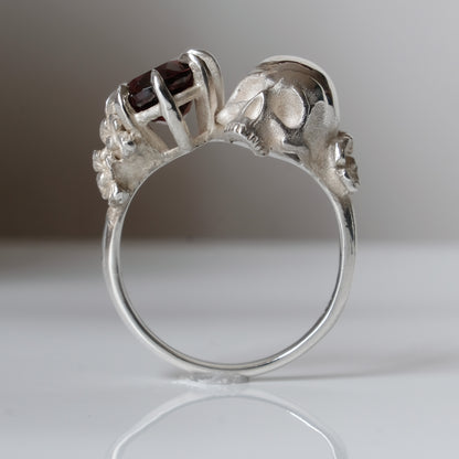 Silver skull and garnet ring with decorative flowers by Charlie Shires jewellery