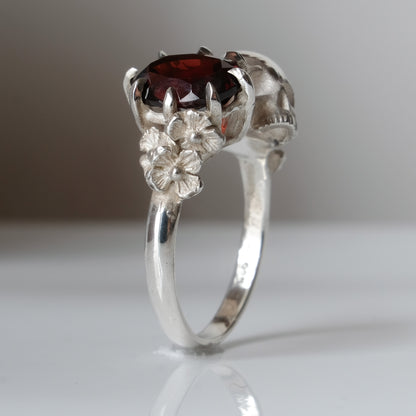 Silver skull and garnet ring with decorative flowers by Charlie Shires jewellery