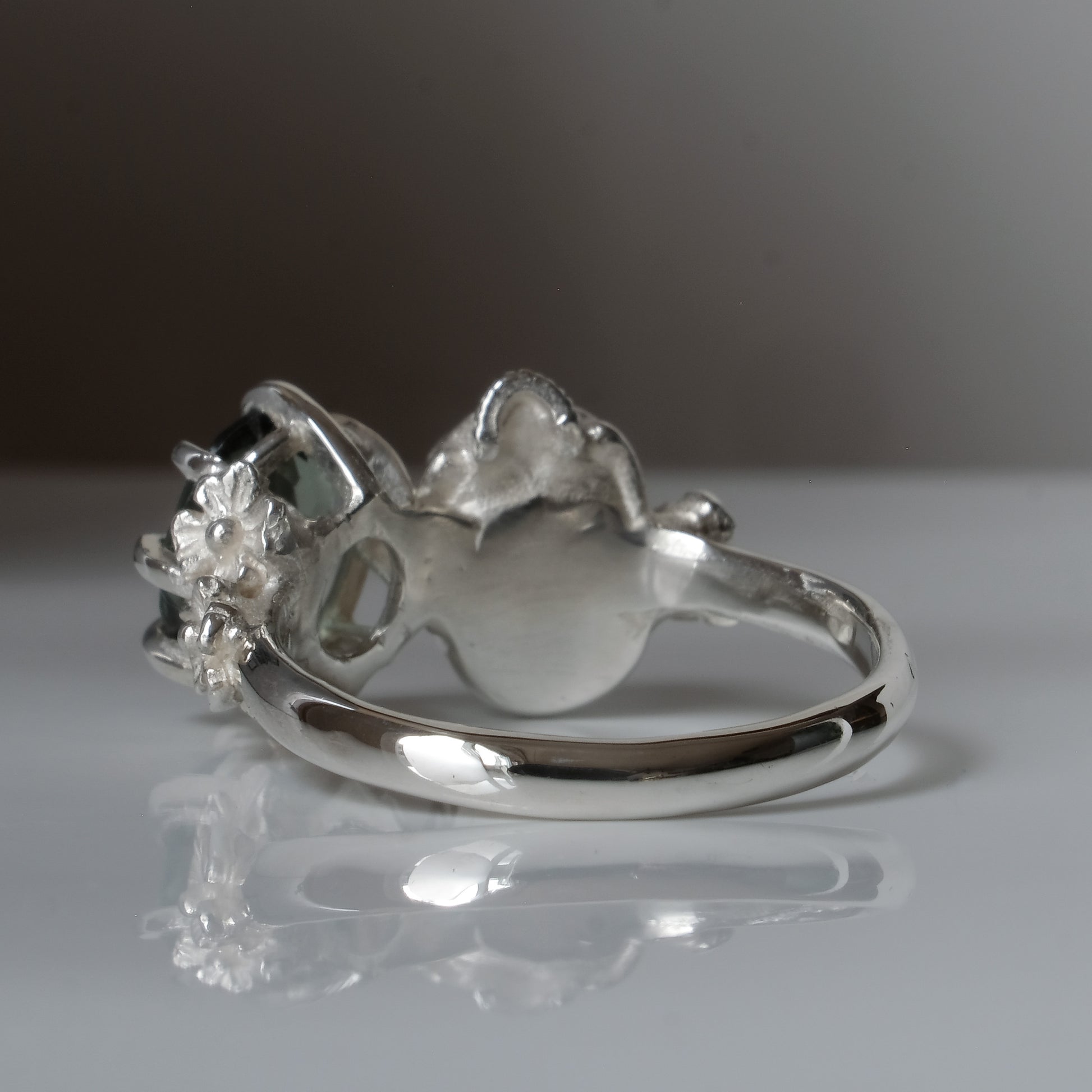 Silver skull and synthetic tourmaline ring with decorative flowers