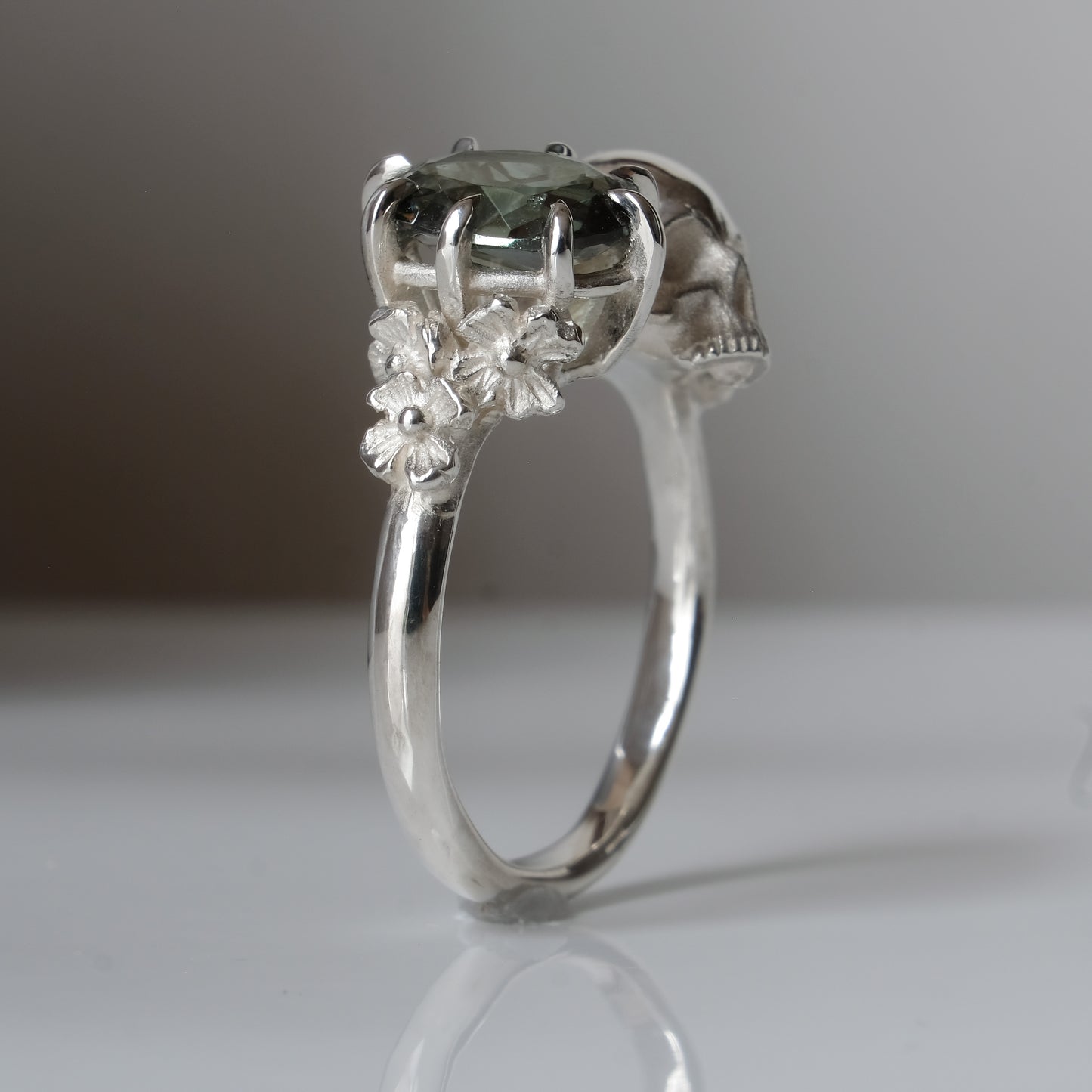 Silver skull and synthetic tourmaline ring with decorative flowers