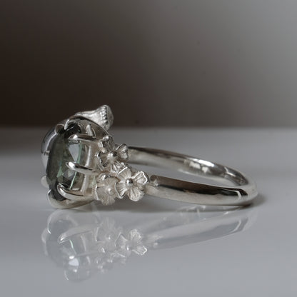 Silver skull and synthetic tourmaline ring with decorative flowers