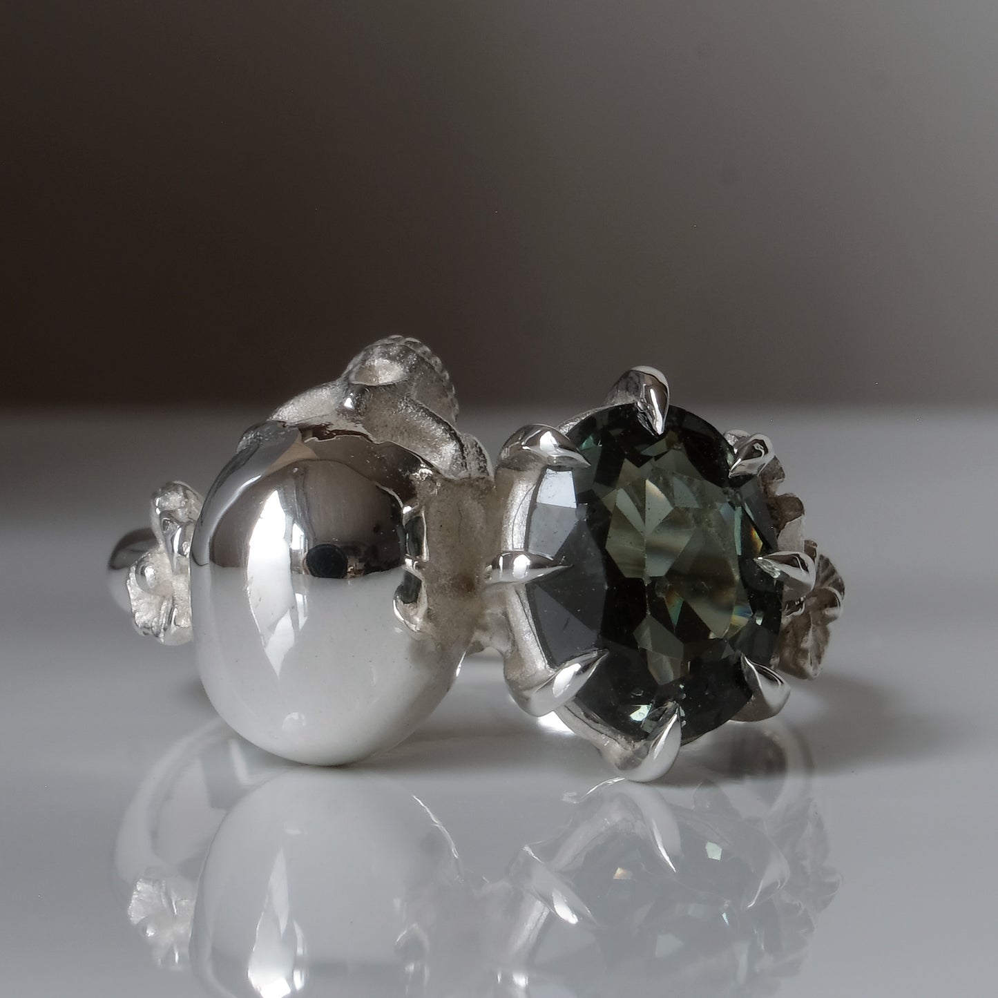 Silver skull and synthetic tourmaline ring with decorative flowers