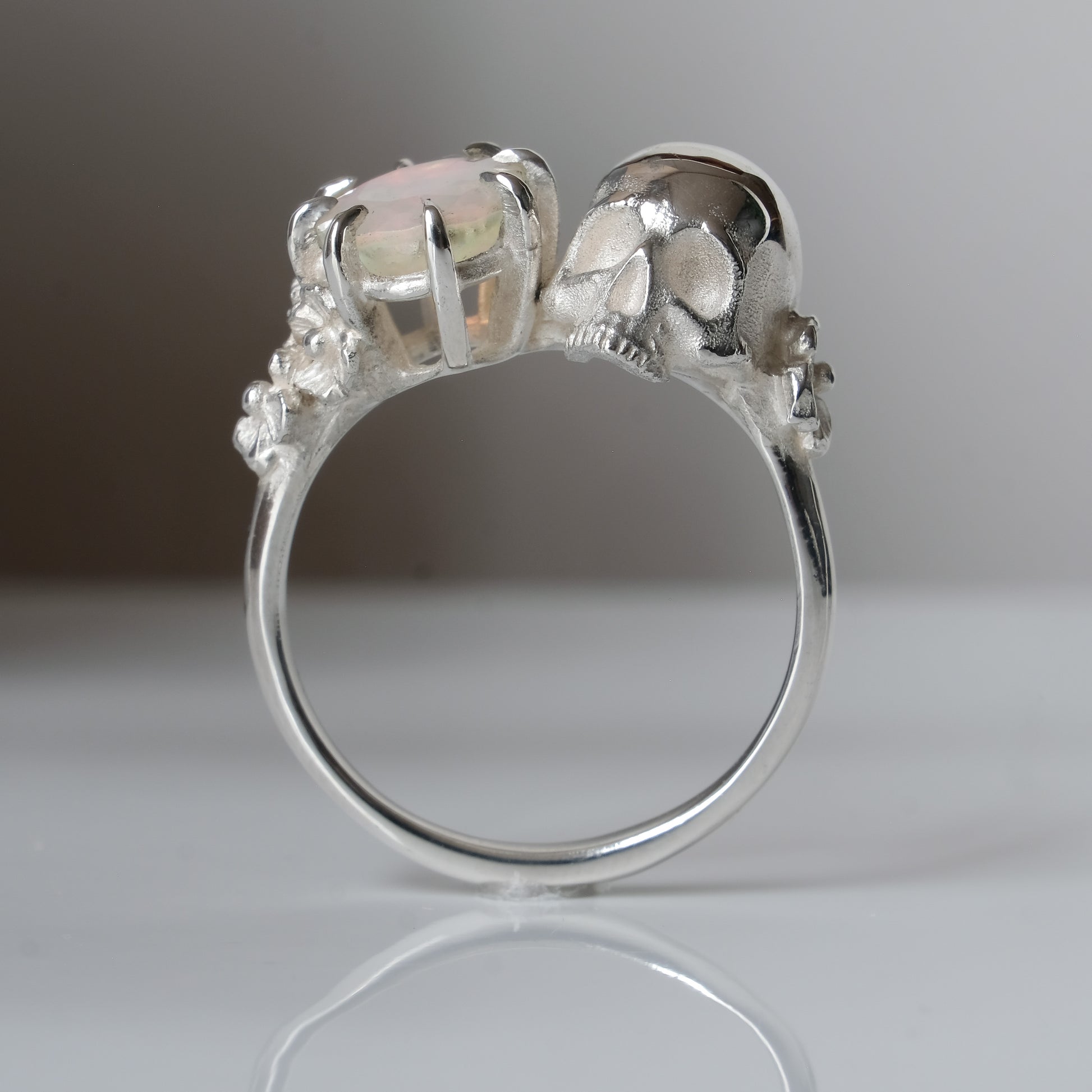 Silver skull and white opal ring with decorative flowers