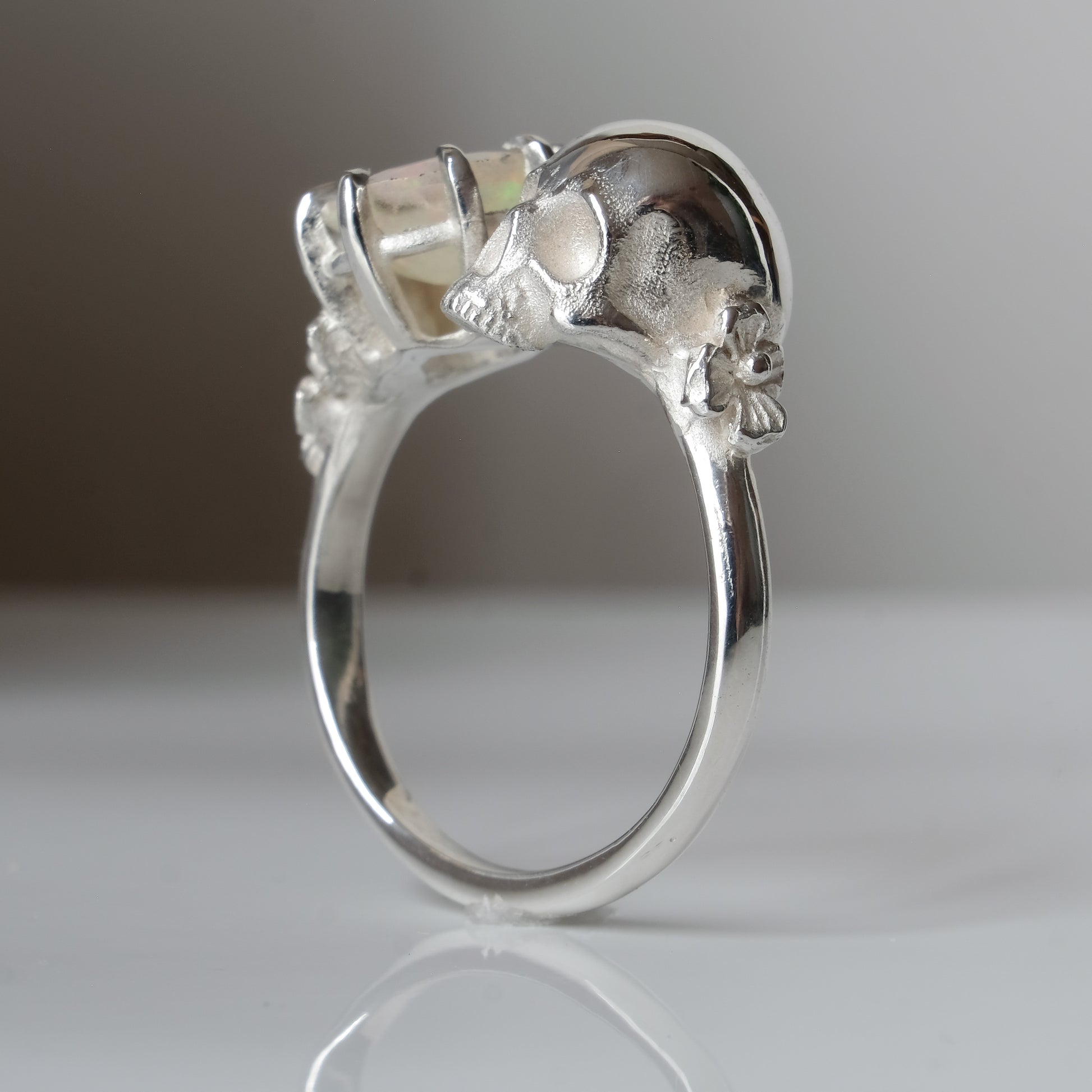 Silver skull and white opal ring with decorative flowers