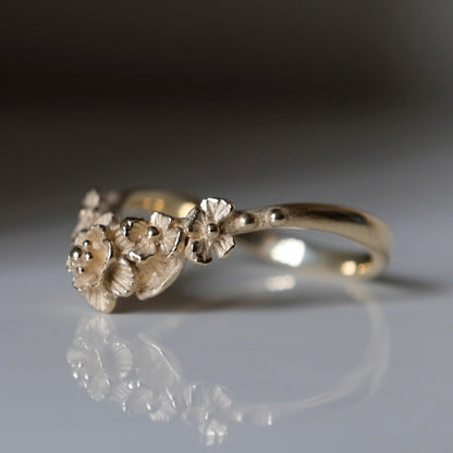 Wishbone shaped stack ring decorated with flowers and leaves. Made in London in 9ct yellow gold by Charlie Shires