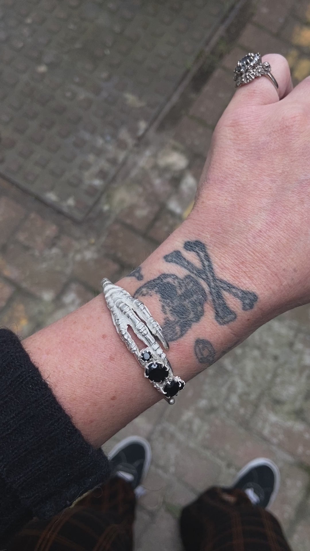 Sterling silver birds claw talon bangle handmade with black spinel stones and flowers in London by Charlie Shires